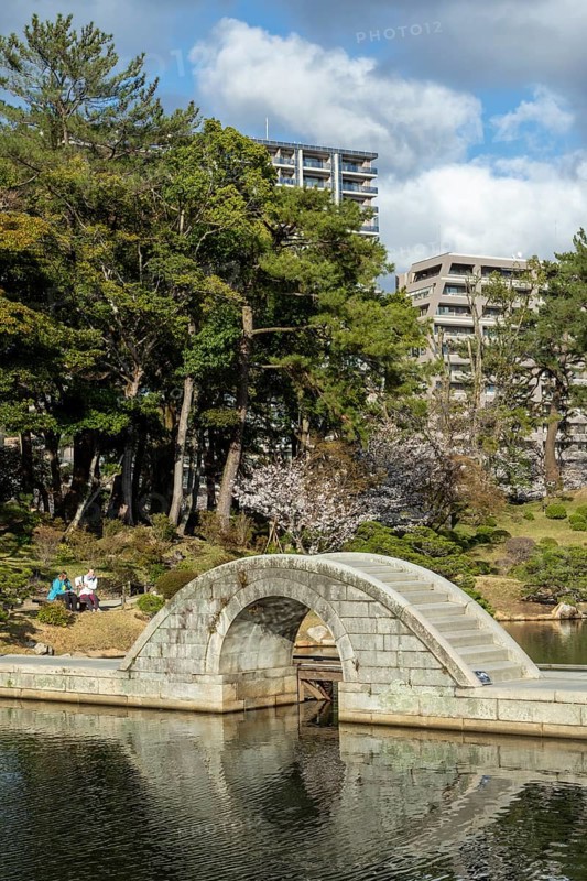Shukkei-en with Koko-kyo stone bridge over Takuei-chi pond in spring, historical Japanese strolling garden, Japanese garden, green area, tourist attraction, sight, Naka-ku, Hiroshima, Japan