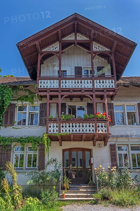 Old villa with wooden shingle façade, large balcony with floral decorations, around 1900, Dornbirn, Vorarlberg, Austria