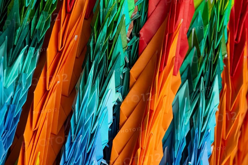 Chains of colourful origami cranes made of paper as a sign of peace in the Peace Park, close-up, background image, landmark, UNESCO World Heritage Site, peace memorial and memorial to the victims of the atomic bombing of Hiroshima, Naka Ward, Hiroshima, Japan