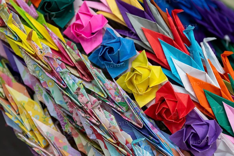 Chains of colourful origami cranes made of paper as a sign of peace in the Peace Park, close-up, background image, landmark, UNESCO World Heritage Site, peace memorial and memorial to the victims of the atomic bombing of Hiroshima, Naka Ward, Hiroshima, Japan