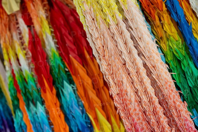 Chains of colourful origami cranes made of paper as a sign of peace in the Peace Park, close-up, background image, landmark, UNESCO World Heritage Site, peace memorial and memorial to the victims of the atomic bombing of Hiroshima, Naka Ward, Hiroshima, Japan