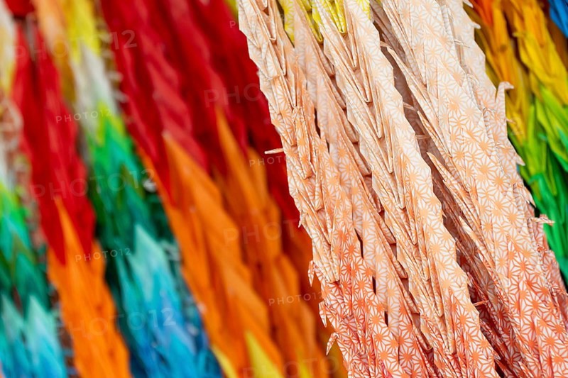 Chains of colourful origami cranes made of paper as a sign of peace in the Peace Park, close-up, background image, landmark, UNESCO World Heritage Site, peace memorial and memorial to the victims of the atomic bombing of Hiroshima, Naka Ward, Hiroshima, Japan