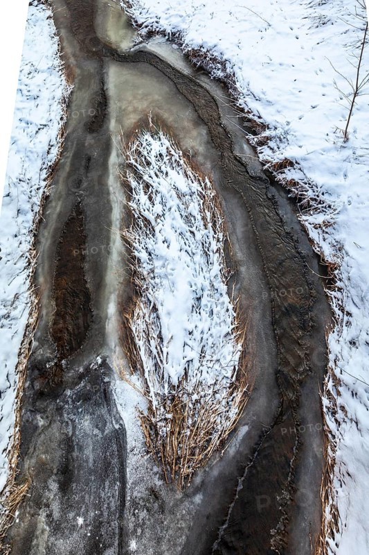 Aerial view of a partially frozen stream surrounded by snow, Kamptal Waldviertel Austria