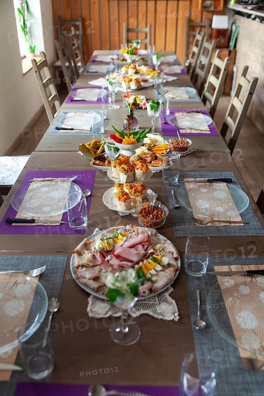 A long table with a table setting in a rustic room, decorated with flowers and crockery, Lower Austria Austria