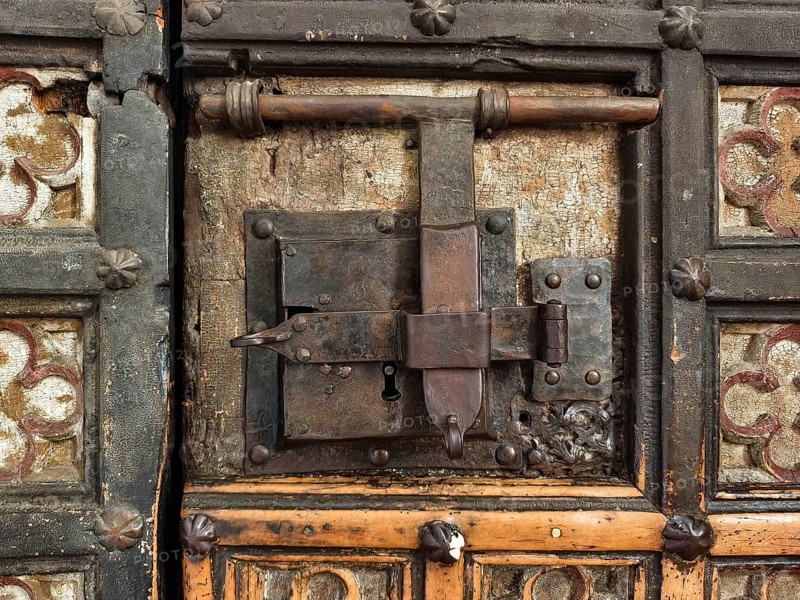 An old, rustic lock system on a wooden and decorated door, Lower Austria Austria