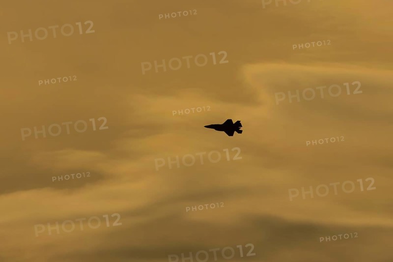 Lockheed Martin F-35 Lightning II fighter military aircraft of the United States air force USAF silhouette in flight at sunset at RAF Lakenheath airbase, Suffolk, England, United Kingdom