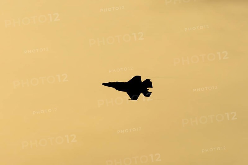 Lockheed Martin F-35 Lightning II fighter military aircraft of the United States air force USAF silhouette in flight at sunset at RAF Lakenheath airbase, Suffolk, England, United Kingdom