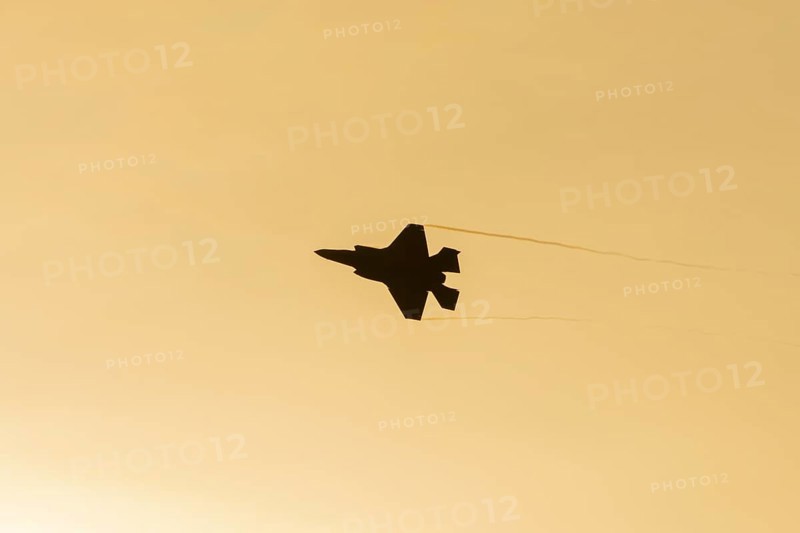 Lockheed Martin F-35 Lightning II fighter military aircraft of the United States air force USAF silhouette in flight at sunset at RAF Lakenheath airbase, Suffolk, England, United Kingdom