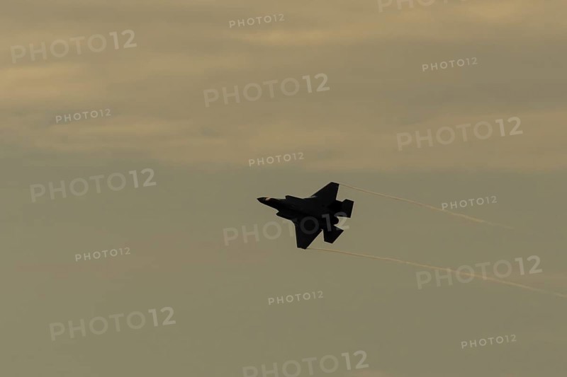 Lockheed Martin F-35 Lightning II fighter military aircraft of the United States air force USAF silhouette in flight at sunset at RAF Lakenheath airbase, Suffolk, England, United Kingdom