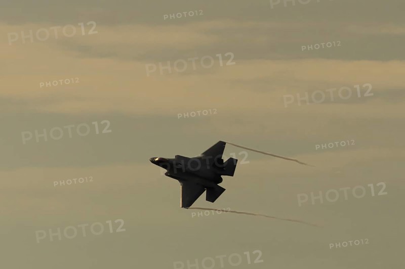 Lockheed Martin F-35 Lightning II fighter military aircraft of the United States air force USAF silhouette in flight at sunset at RAF Lakenheath airbase, Suffolk, England, United Kingdom