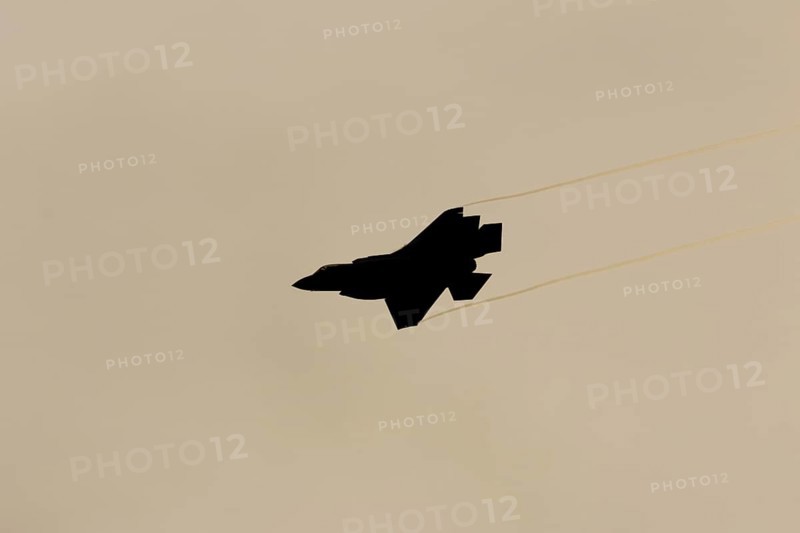 Lockheed Martin F-35 Lightning II fighter military aircraft of the United States air force USAF silhouette in flight at sunset at RAF Lakenheath airbase, Suffolk, England, United Kingdom