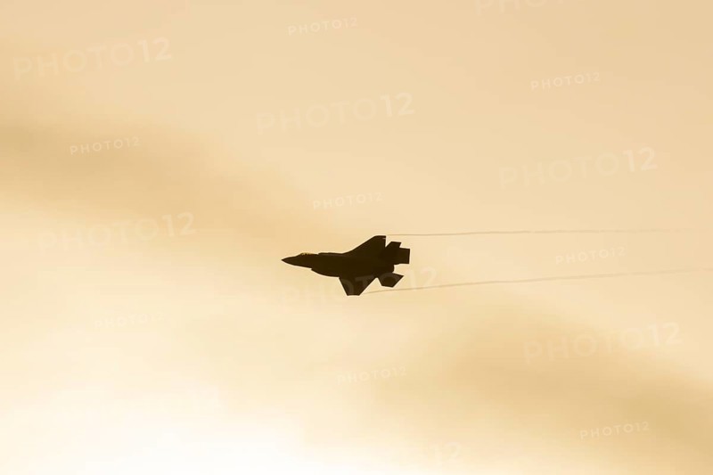 Lockheed Martin F-35 Lightning II fighter military aircraft of the United States air force USAF silhouette in flight at sunset at RAF Lakenheath airbase, Suffolk, England, United Kingdom