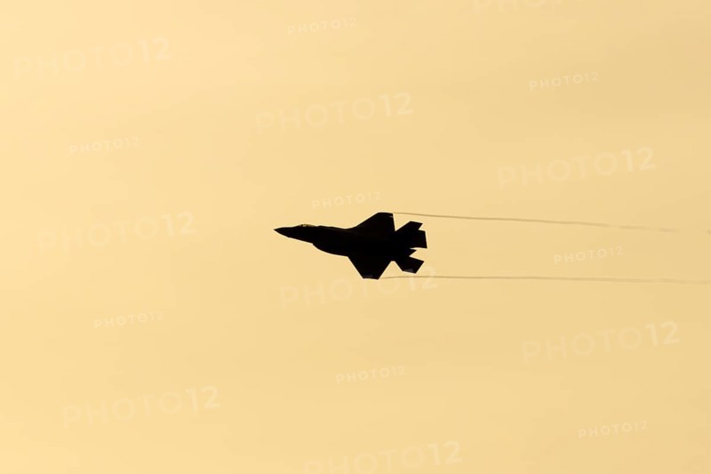 Lockheed Martin F-35 Lightning II fighter military aircraft of the United States air force USAF silhouette in flight at sunset at RAF Lakenheath airbase, Suffolk, England, United Kingdom