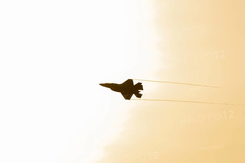 Lockheed Martin F-35 Lightning II fighter military aircraft of the United States air force USAF silhouette in flight at sunset at RAF Lakenheath airbase, Suffolk, England, United Kingdom