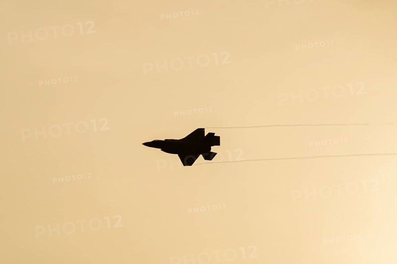 Lockheed Martin F-35 Lightning II fighter military aircraft of the United States air force USAF silhouette in flight at sunset at RAF Lakenheath airbase, Suffolk, England, United Kingdom