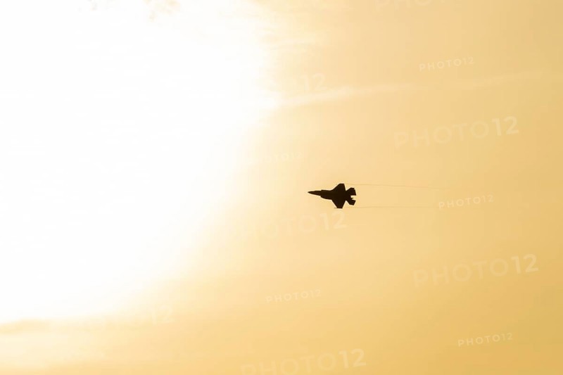 Lockheed Martin F-35 Lightning II fighter military aircraft of the United States air force USAF silhouette in flight at sunset at RAF Lakenheath airbase, Suffolk, England, United Kingdom
