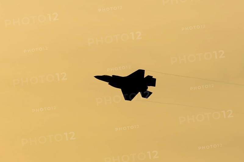 Lockheed Martin F-35 Lightning II fighter military aircraft of the United States air force USAF silhouette in flight at sunset at RAF Lakenheath airbase, Suffolk, England, United Kingdom