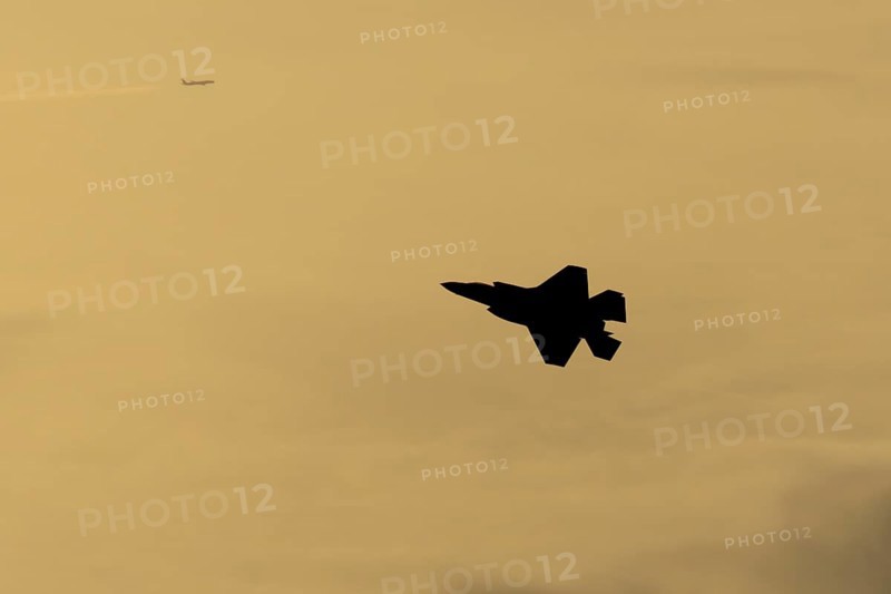 Lockheed Martin F-35 Lightning II fighter military aircraft of the United States air force USAF silhouette in flight at sunset at RAF Lakenheath airbase, Suffolk, England, United Kingdom