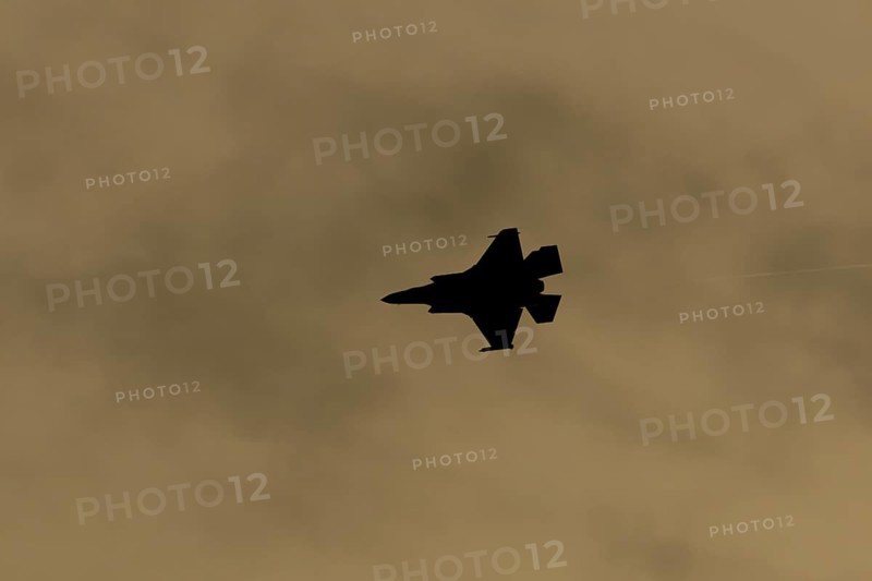 Lockheed Martin F-35 Lightning II fighter military aircraft of the United States air force USAF silhouette in flight at sunset at RAF Lakenheath airbase, Suffolk, England, United Kingdom