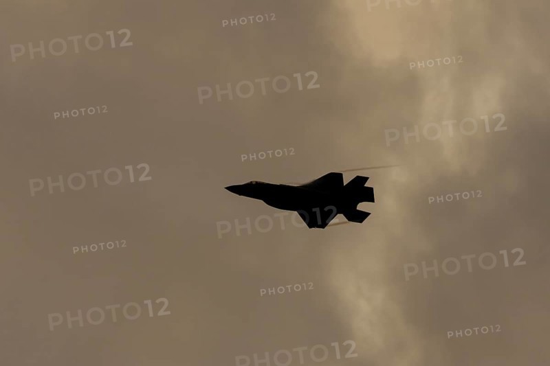 Lockheed Martin F35 Lightning II fighter military aircraft of the United States air force USAF silhouette in flight at sunset at RAF Lakenheath airbase, Suffolk, England, United Kingdom