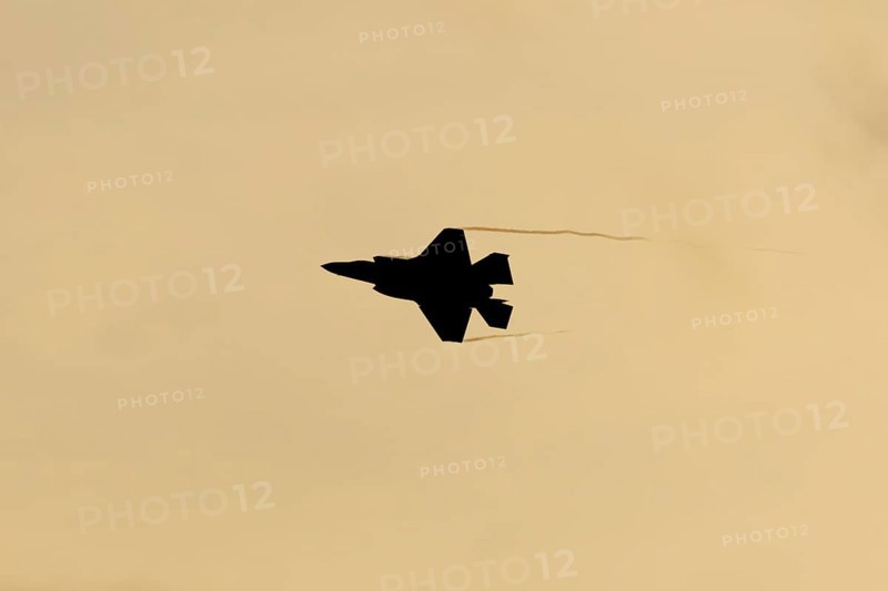 Lockheed Martin F35 Lightning II fighter military aircraft of the United States air force USAF silhouette in flight at sunset at RAF Lakenheath airbase, Suffolk, England, United Kingdom