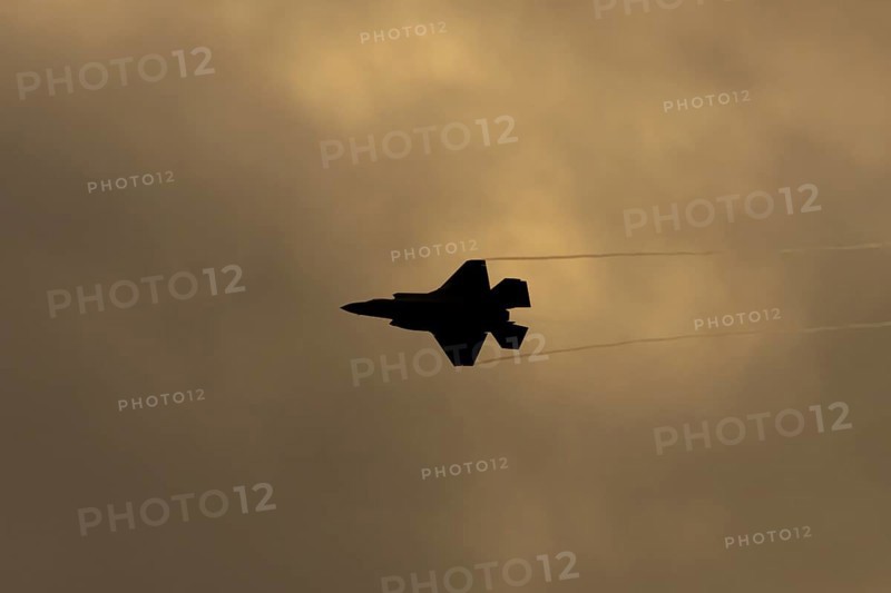 Lockheed Martin F-35 Lightning II fighter military aircraft of the United States air force USAF silhouette in flight at sunset at RAF Lakenheath airbase, Suffolk, England, United Kingdom