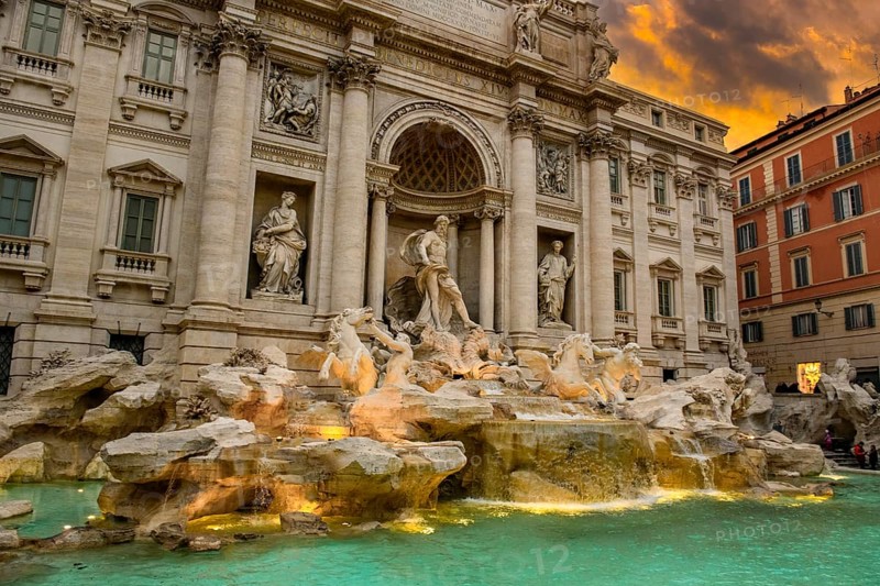 View at dusk in the evening twilight with dramatic light in the sky on partially illuminated fountain Fontana di Trevi in historic centre of Rome, Rome, Lazio, Italy