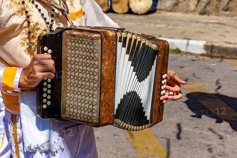 Accordionist with his instrument at the Congado festival in Minas Gerais, Belo Horizonte, Minas Gerais, Brazil