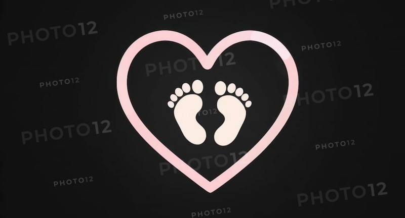 A pink heart with baby footprints inside on a black background, perfect for baby-related themes. The heart symbolizes love and care, AI generated