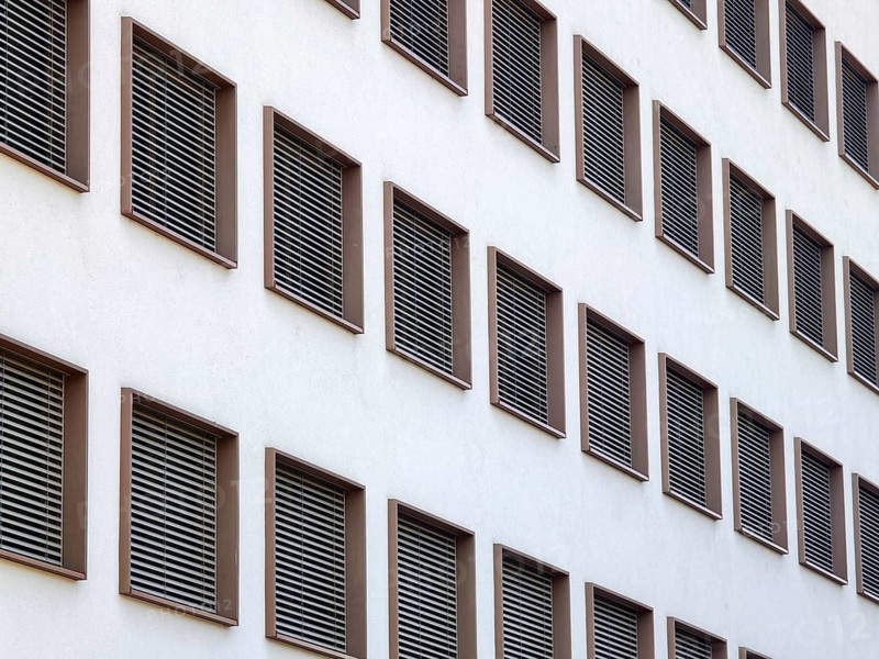 Modern building view with regular window arrangements and ventilation grilles in minimalist aesthetics Mödling Lower Austria Austria