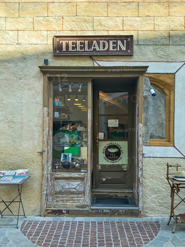 Entrance to a small, cosy tea shop in an old town with decorative shop window Mödling Lower Austria Austria