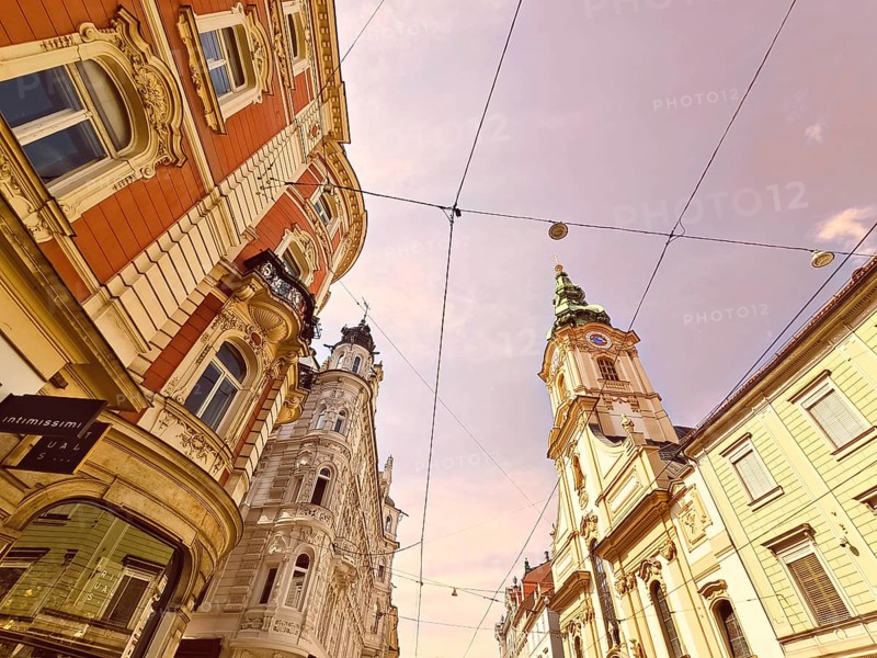 View of ornate historic buildings of a city under a sunny sky Herz Jesu Kirche Graz Styria Austria