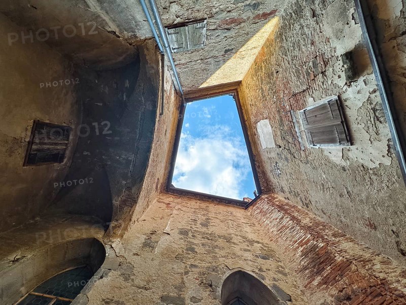 View through an open roof of blue sky with clouds surrounded by old stone walls Riegersburgs Styria Austria