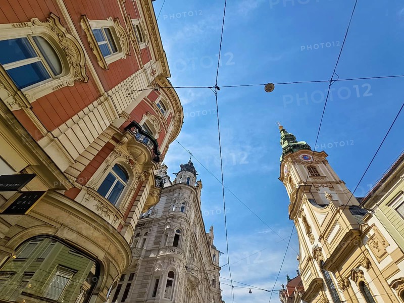 Historic buildings in an urban setting, spanned by a blue sky Herz Jesu Kirche Graz Styria Austria