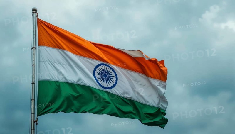 The Indian flag waves proudly against a cloudy sky, symbolizing the nation's independence and cultural heritage. The tricolor is fully displayed, AI generated