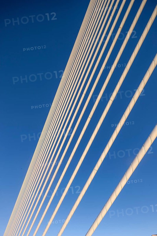 Close-up of cables of a bridge against a clear blue sky