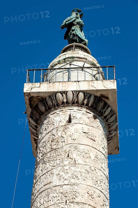 View from bottom to top of statue of Apostle Peter, Saint Peter, Saint Peter, erected in 1587 at the behest of Pope Sixtus V, below platform with railing and parts of spiral marble relief on column of honour Victory Column Trajan's Column from 113 Lunensian marble Carrara marble from for Roman Emperor Trajan from antiquity in Trajan's Forum in ancient Rome, Rome, Lazio, Italy