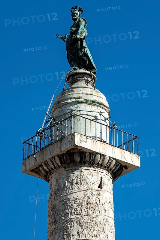 View of statue of Apostle Peter, St. Peter, Saint Peter, erected in 1587 at the behest of Pope Sixtus V, including small platform with railing and parts of spiral marble relief on column of honour Victory Column from year 113 made of Carrara marble from Lunensian marble for Roman Emperor Trajan from antiquity in Trajan's Forum in ancient Rome, Rome, Lazio, Italy