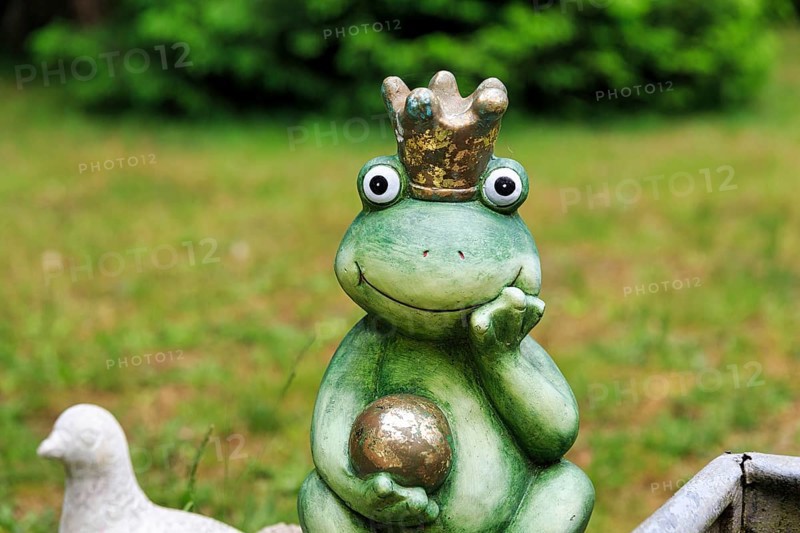 Sculpture of a frog king with crown and golden ball, decoration in the garden, Schloss Holte-Stukenbrock, North Rhine-Westphalia, Germany