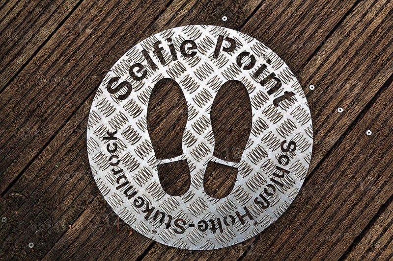 Selfie point, metal plate, shoe prints on a plank path at the source of the River Ems near Schloss Holte-Stukenbrock, Senne nature reserve, Teutoburg Forest, North Rhine-Westphalia, Germany