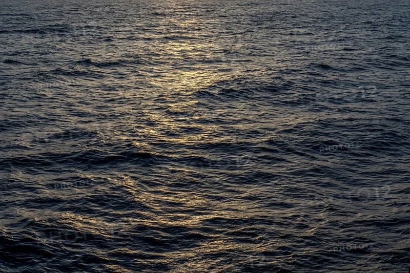 Background image, water surface in evening light, waves in the sea at sunset, Tokyo Bay, Japan