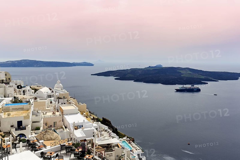 View from the island capital Fira to the uninhabited volcanic island Nea Kameni in the caldera, cruise ship, haze, Santorini, Cyclades, Greece