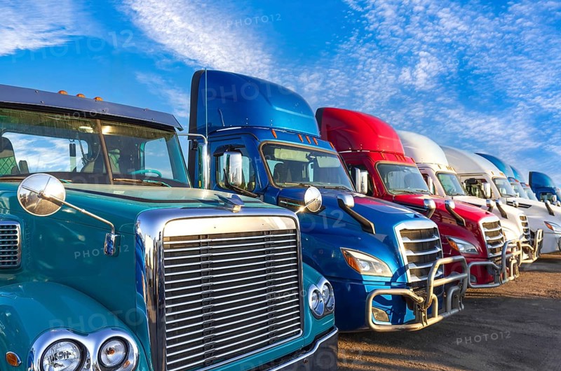 Long haul container trucks carrying commercial cargo on a parking lot ready for delivery