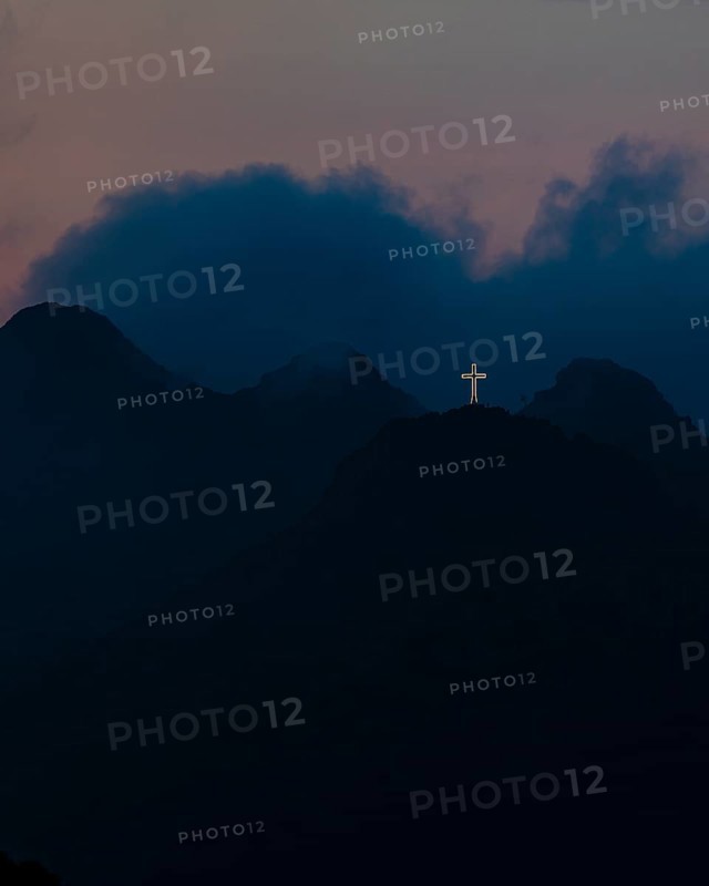 Illuminated steel cross on Monte Mar di Capanna, night shot, above Porto Azzurro, Elba Island, Tuscan Archipelago National Park, Tuscany, Italy