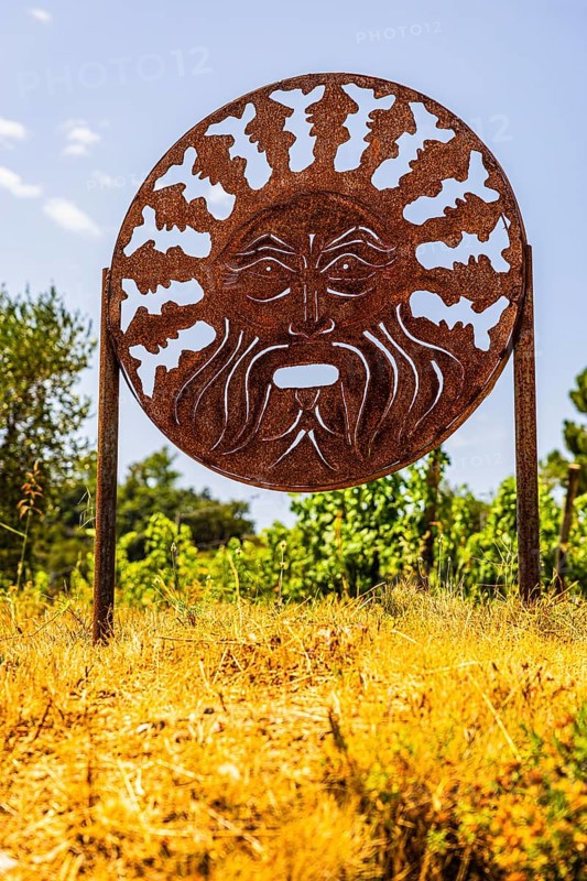 Rusty plaque with motif of the god of wine Bacchus, near the Arrighi winery, Porto Azzurro, Elba Island, Tuscan Archipelago National Park, Tuscany, Italy