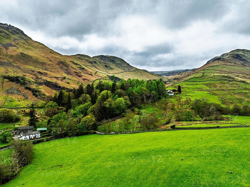 Farms and Mountains over road A591 from a drone, Grasmere Lake, Grasmere, Ambleside, Lake District, Westmorland, Cumbria, UK