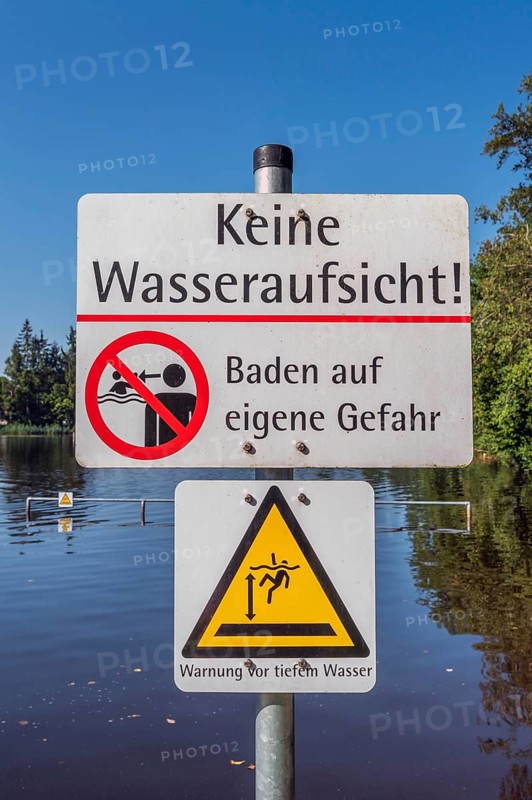 Warning sign, no water supervision, bathing at your own risk in the ArgenbÃ¼hl moor pool near Eisenharz, Baden-WÃ¼rttemberg, Germany