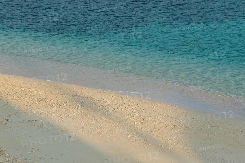 Sunlight, shade, sand and turquoise water at Sesoko-jima beach, Sesoko Island, Motobu, Kunigami District, Okinawa, Japan