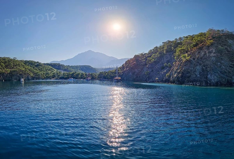 Wonderful Paradise bay of Camyuva, Kemer, Turkey. Scenery sea view to the coast with boats on the blue water. Summertime holiday seascape