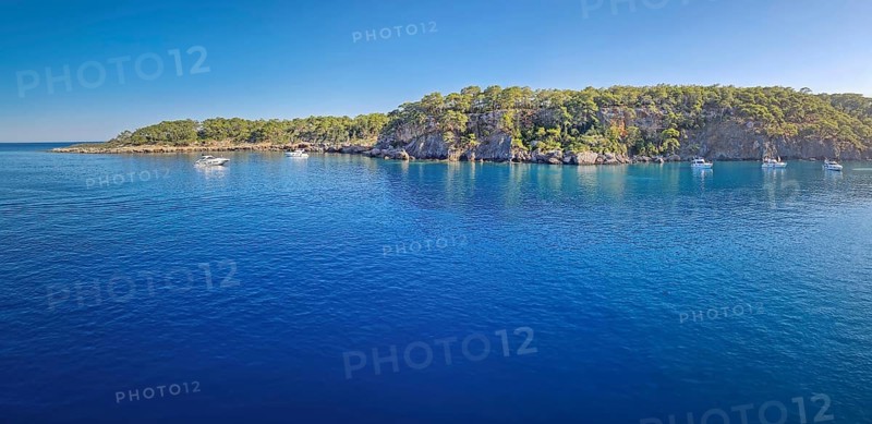Wonderful Paradise bay of Camyuva, Kemer, Turkey. Scenery panoramic view of the coast with boats on the blue sea water. Summertime holiday seascape